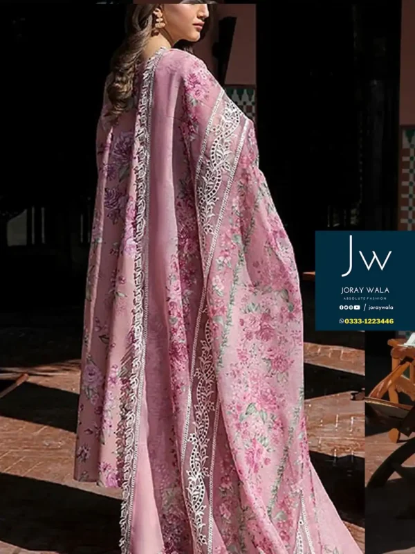 Model wearing Baroque 3 piece suit in pink color, the dress has a beautiful flower pattern.
