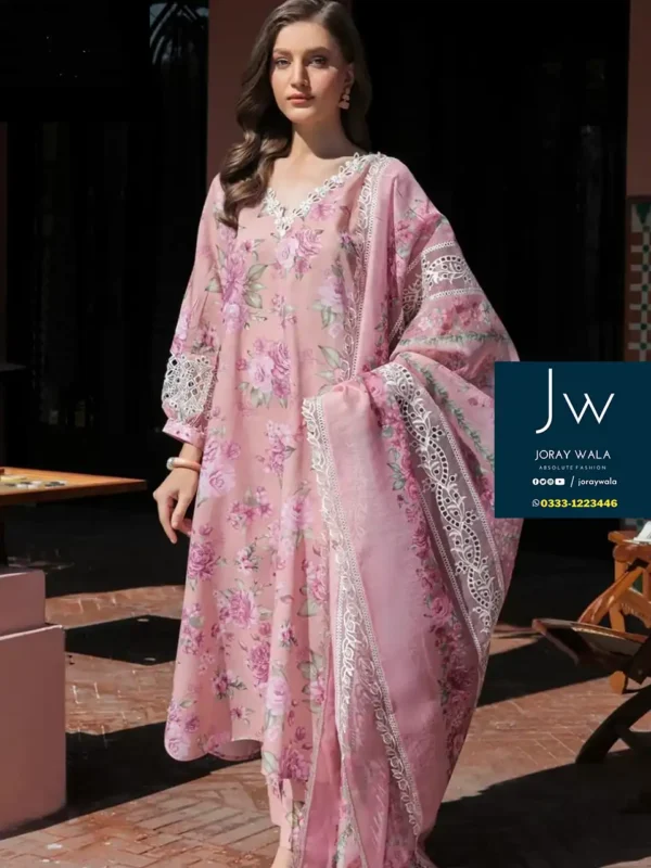 Model wearing Baroque 3 piece suit in pink color, the dress has a beautiful flower pattern.