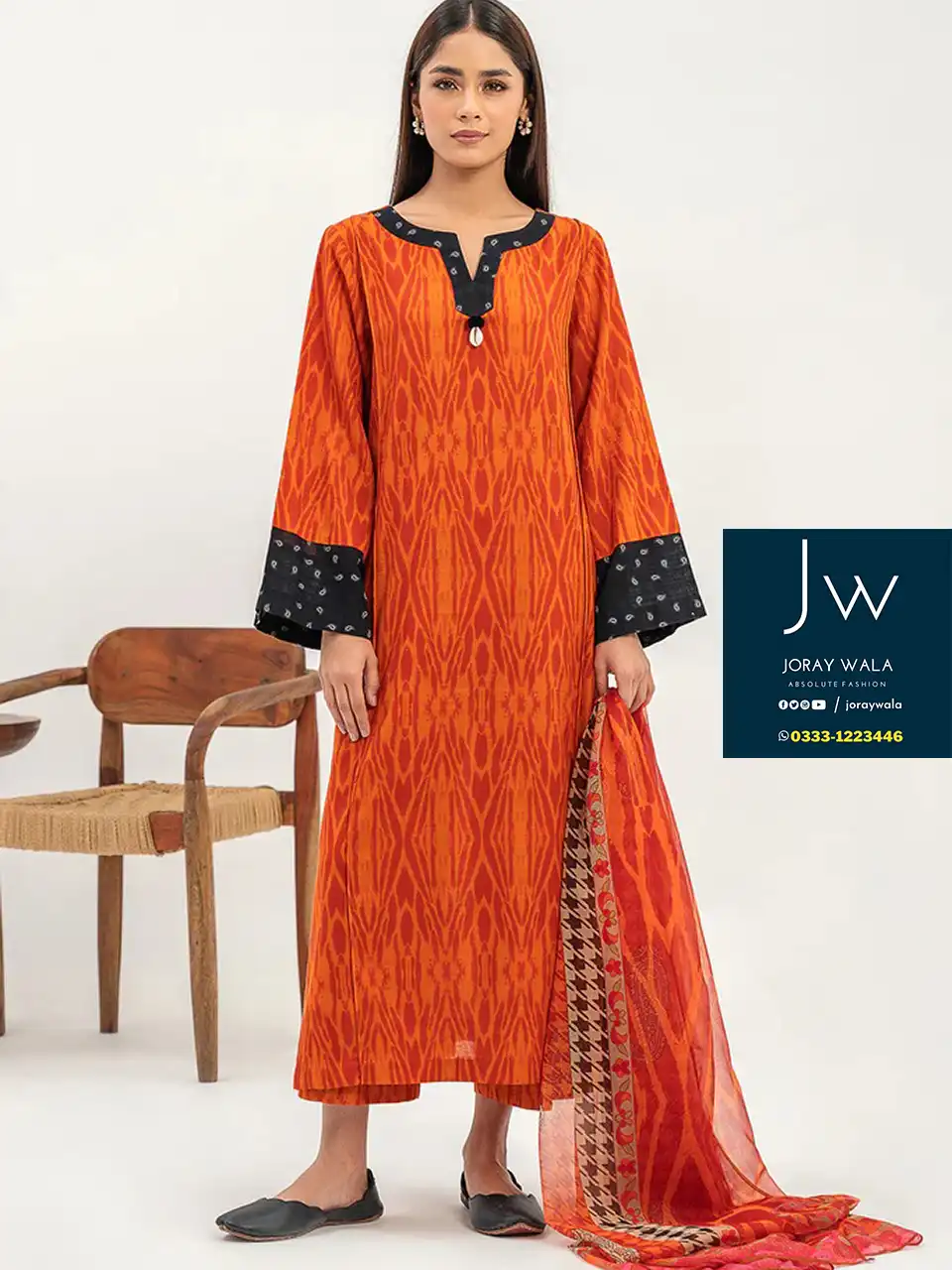 A women wearing Orange color 3 Pcs suit, fabric is swiss lawn