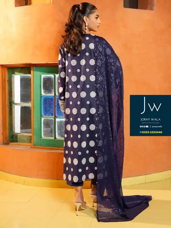 Pakistani model wearing a blue color polka dots 3pcs embroidered suit and the suit is available at joraywala