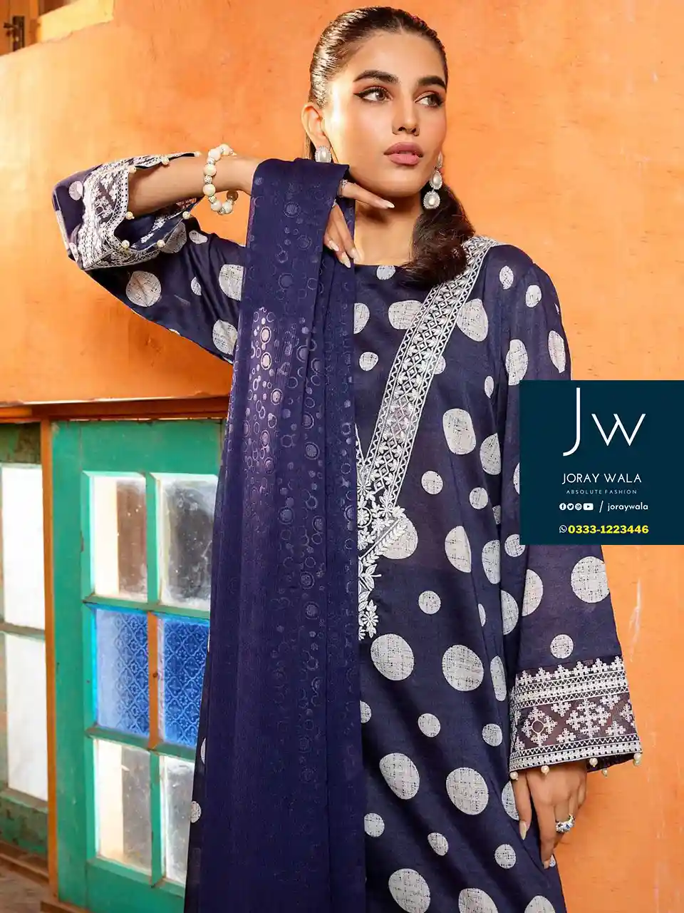 Pakistani model wearing a blue color polka dots 3pcs embroidered suit and the suit is available at joraywala