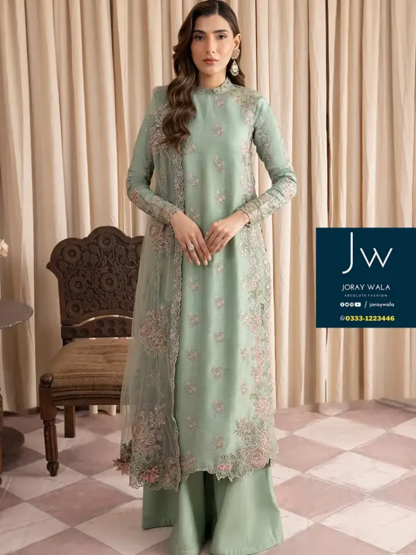 Elegant woman wearing a mint green designer outfit with intricate embroidery, perfect for Pakistani party wear and special occasions.