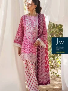 Woman in vibrant pink and white ethnic outfit with intricate patterns, posing gracefully outdoors. and this suit is available at joraywala